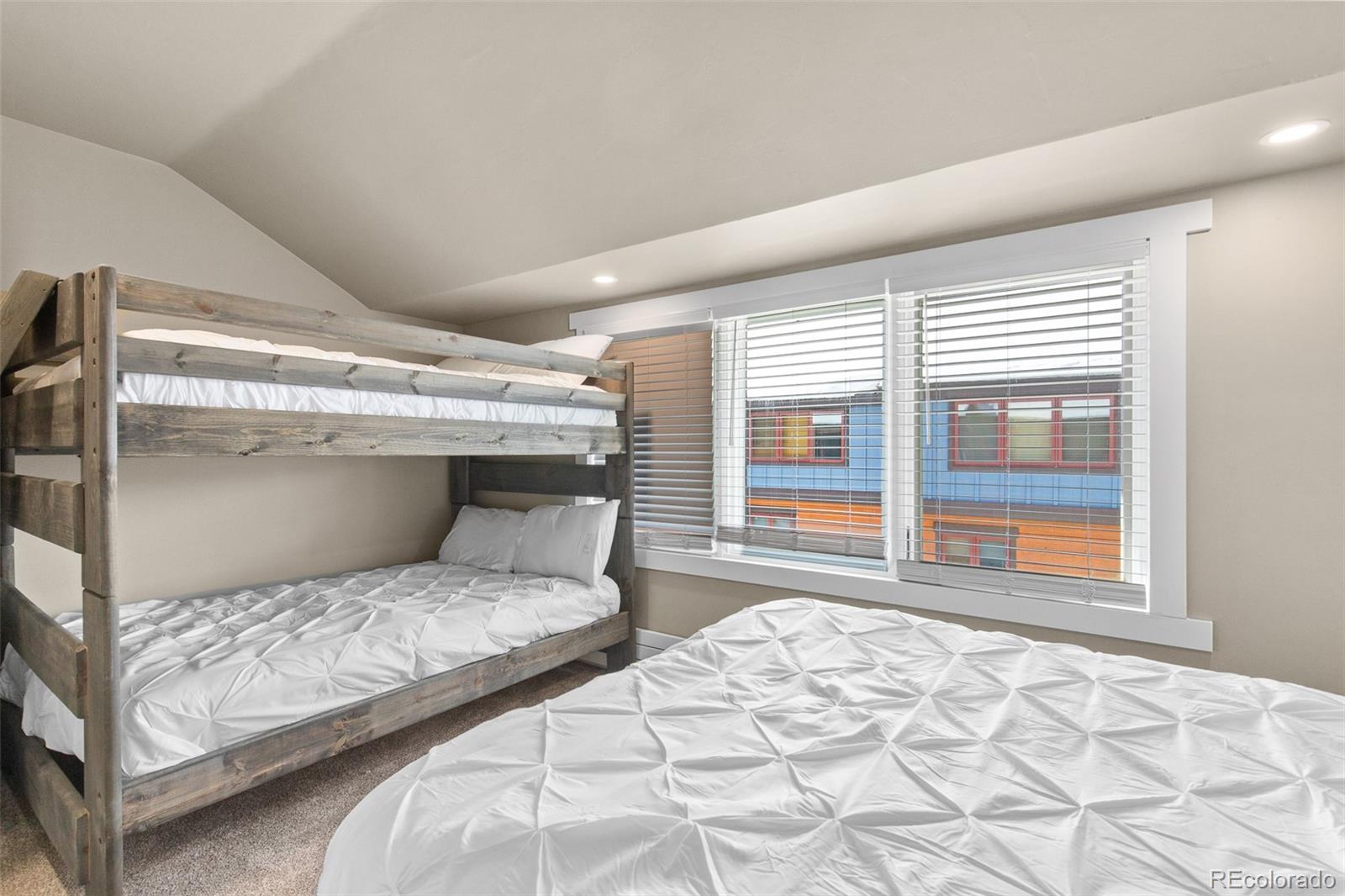200 Primrose Path, Unit 11 Breckenridge, CO 80424 - Photo 17 of 32 a bedroom with a large bed and a large window