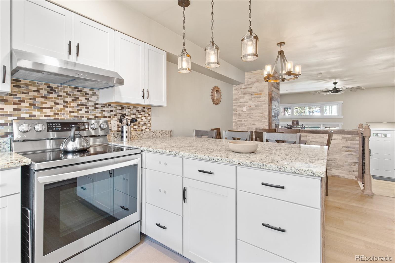 200 Primrose Path, Unit 11 Breckenridge, CO 80424 - Photo 3 of 32 a kitchen with kitchen island granite countertop a sink stainless steel appliances and cabinets