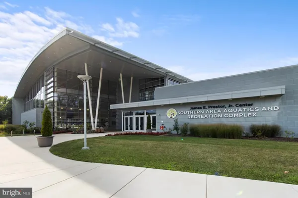 a man walking down a street next to a building