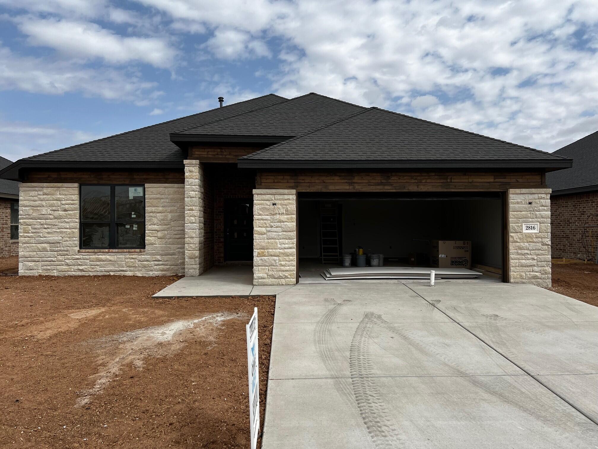 2816 133rd Street Lubbock, TX 79423 - Photo 1 of 3 a front view of a house with a garage
