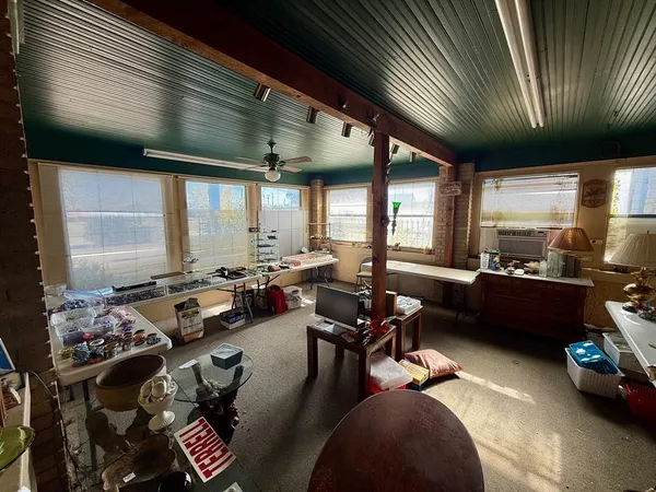a view of a livingroom with furniture and a gym