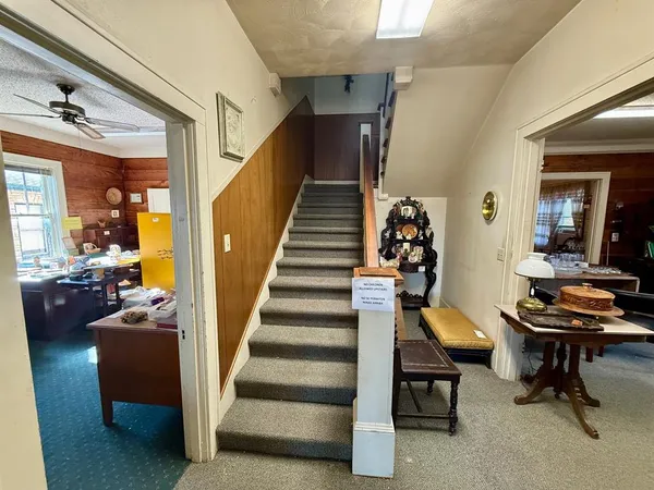 a view of a porch with wooden floor and furniture