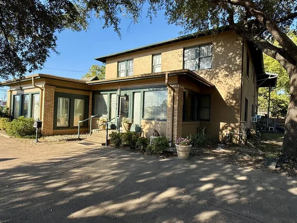 a view of a house with backyard porch and sitting area