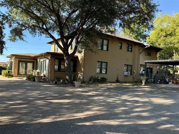 an aerial view of a house with garden space and street view