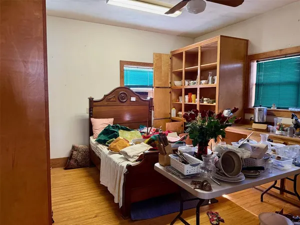 a living room with furniture a chandelier and a dining table