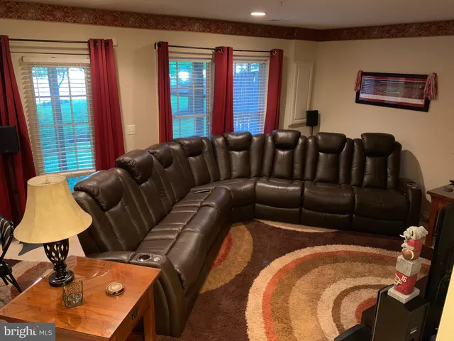 a living room with furniture and a lamp