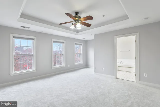 a view of an empty room with a ceiling fan