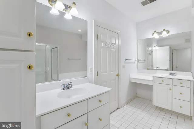 a bathroom with a tub a sink and a shower