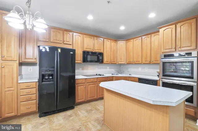 a kitchen with stainless steel appliances granite countertop a refrigerator sink and cabinets