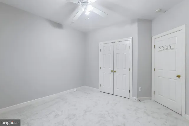 an empty room with a ceiling fan