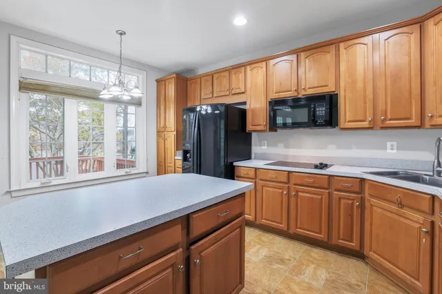 a kitchen with stainless steel appliances granite countertop a refrigerator and cabinets