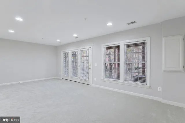 a bathroom with a granite countertop sink toilet and mirror