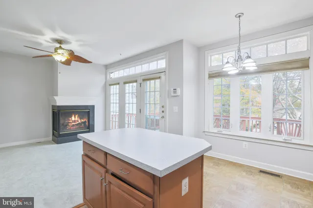 a kitchen with a stove and a chandelier