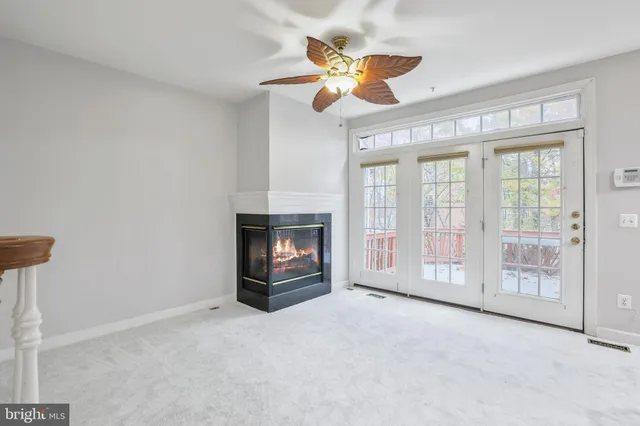 a view of an empty room with a fireplace and a window