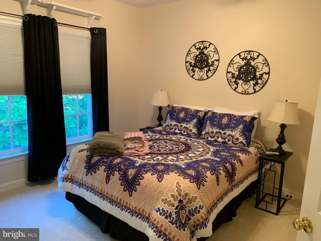 a bed sitting in a bedroom next to a window