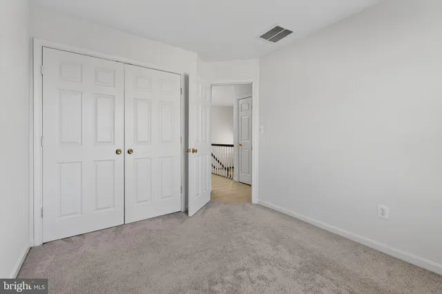 a view of an empty room and a bathroom