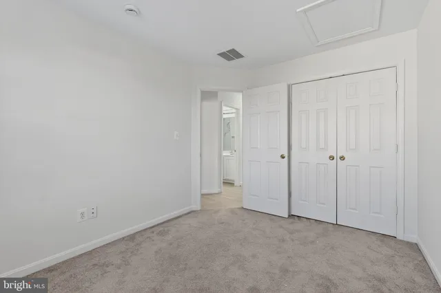 an empty room with closet area