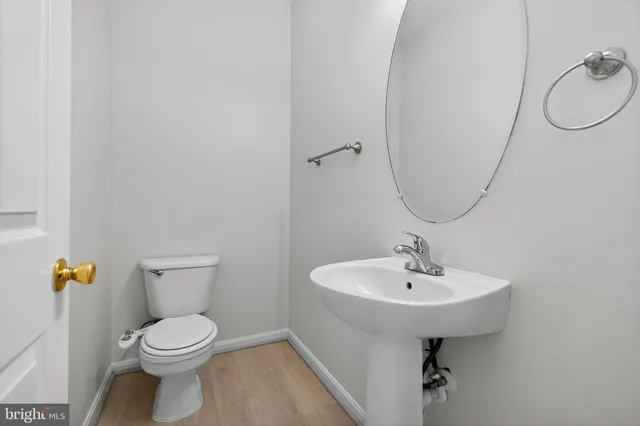 a bathroom with a sink toilet and a mirror