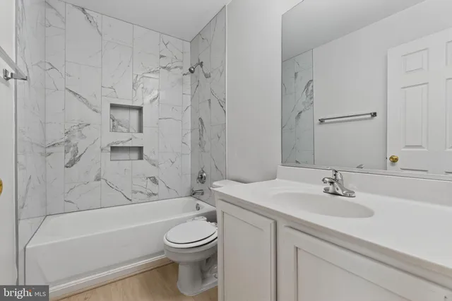 a bathroom with a sink a toilet and a bathtub