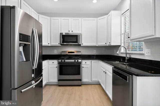 a kitchen with a refrigerator stove and sink