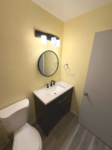 a bathroom with a double vanity sink toilet mirror and shower