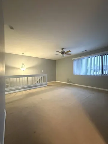 a view of a room with an empty space and window