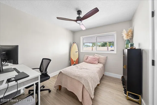 a bathroom with a granite countertop sink a toilet and mirror
