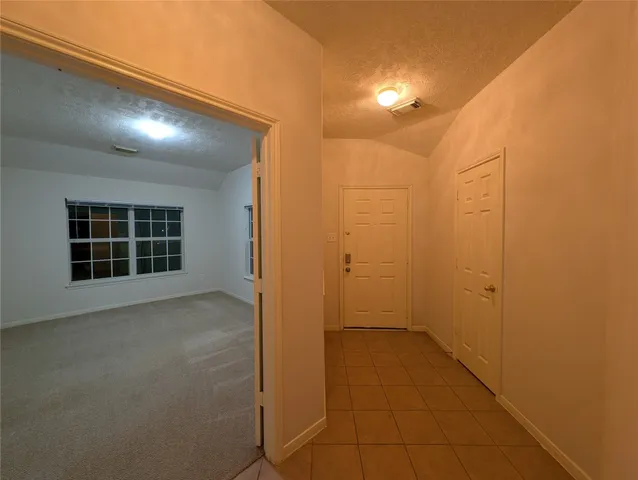 a kitchen with stainless steel appliances granite countertop a stove top oven a sink a dining table and chairs