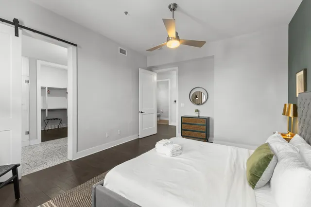 a bedroom with a bed and a chandelier