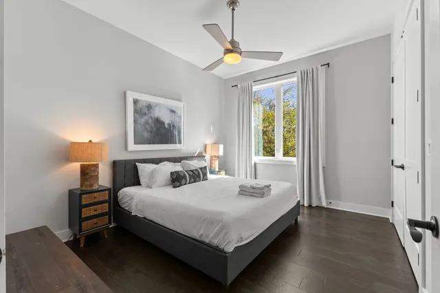 a bedroom with a bed lamp and a window