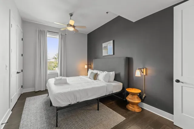 a bedroom with a bed and a lamp with window