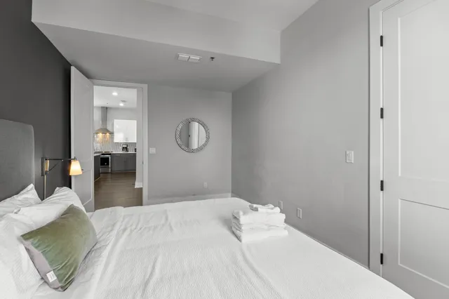 a bedroom with a bed and painting on the wall