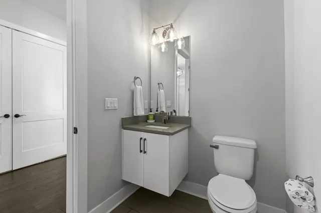 a bathroom with a toilet a sink and mirror