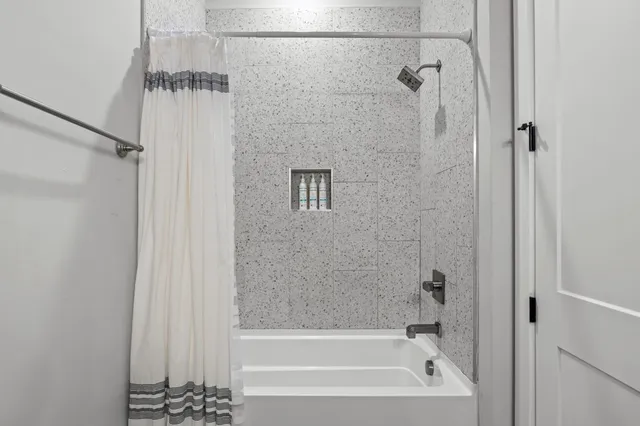 a bathroom with a bathtub and a shower