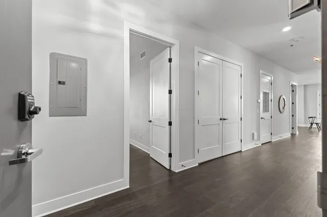 a view of a hallway with wooden floor