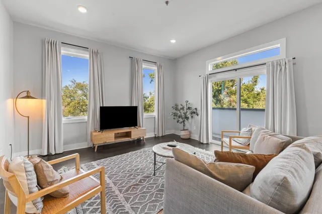 a living room with furniture tv and a window