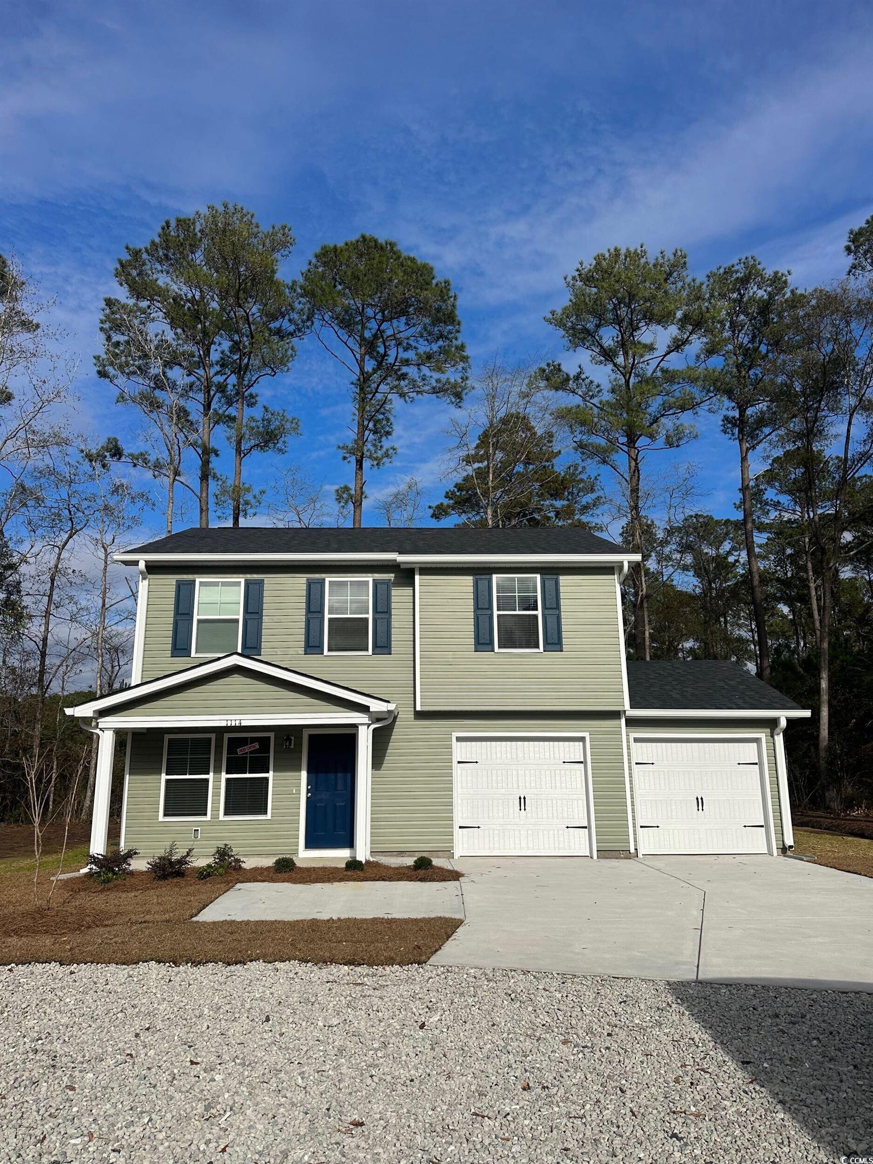 1114 Oscar Road Little River, SC 29566 - Photo 1 of 6 View of front of home featuring concrete driveway, a porch, and an attached garage