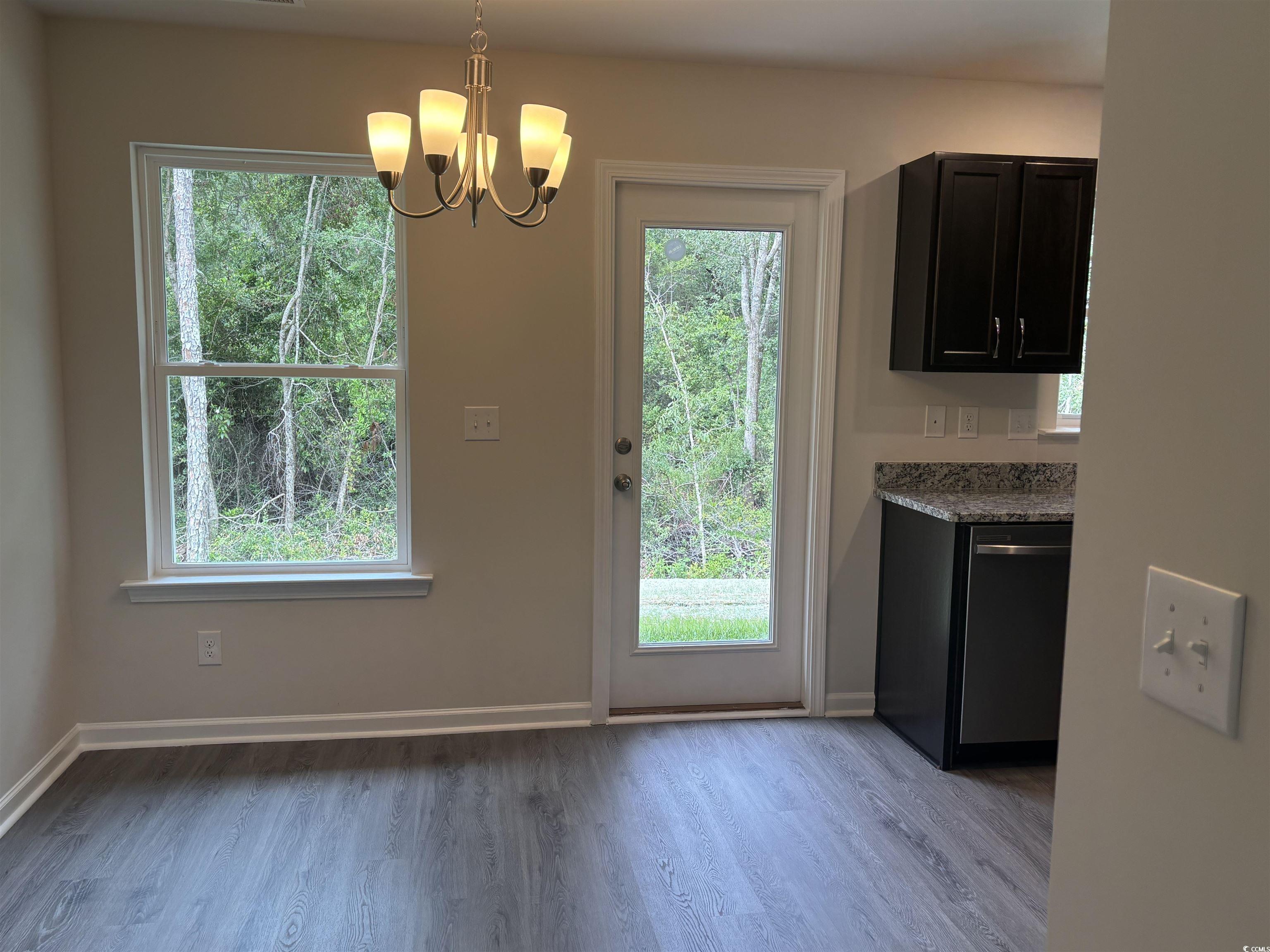1114 Oscar Road Little River, SC 29566 - Photo 3 of 6 Doorway featuring wood finished floors and a chandelier