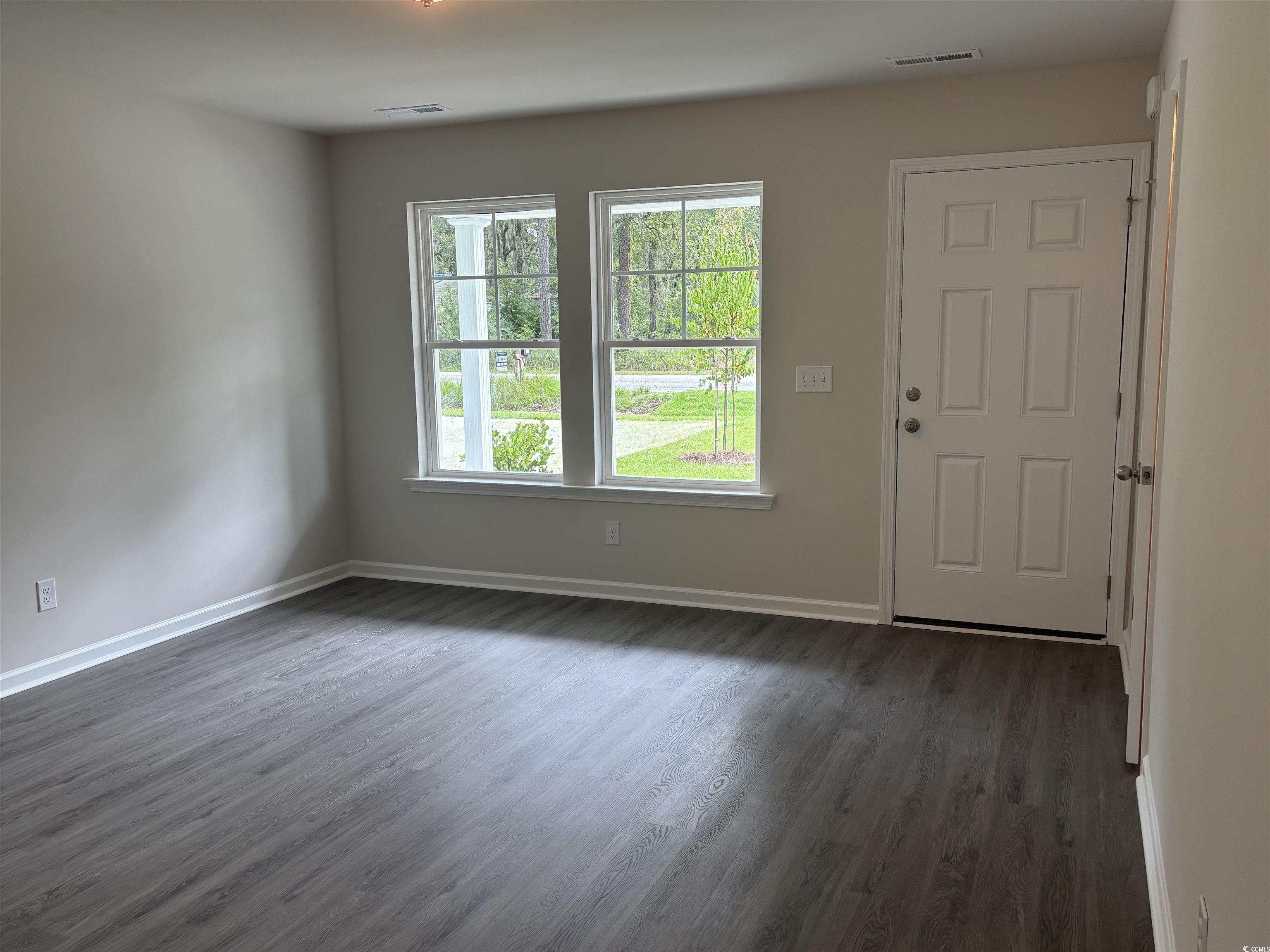 1114 Oscar Road Little River, SC 29566 - Photo 4 of 6 Entrance foyer featuring dark wood-type flooring and baseboards