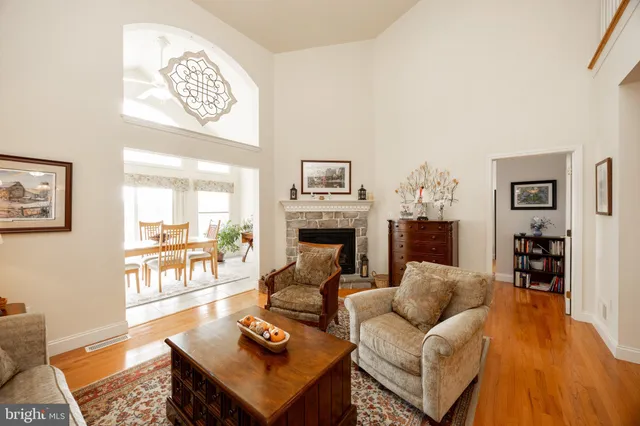 a living room with furniture a fireplace and a table