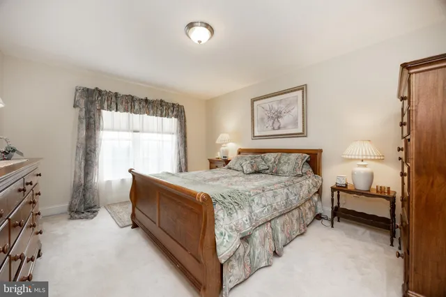 a bedroom with a bed and a painting