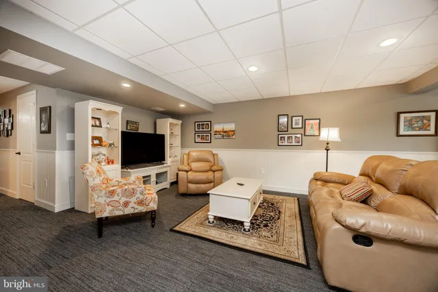 a living room with furniture and kitchen view