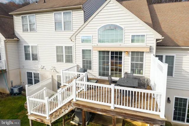 a view of a house with a wooden deck