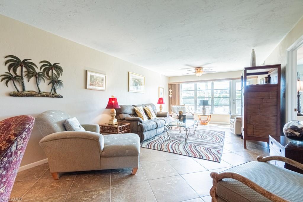 3662 Arctic Circle, Unit 201 Naples, FL 34112 - Photo 12 of 35 a living room with furniture and a large window
