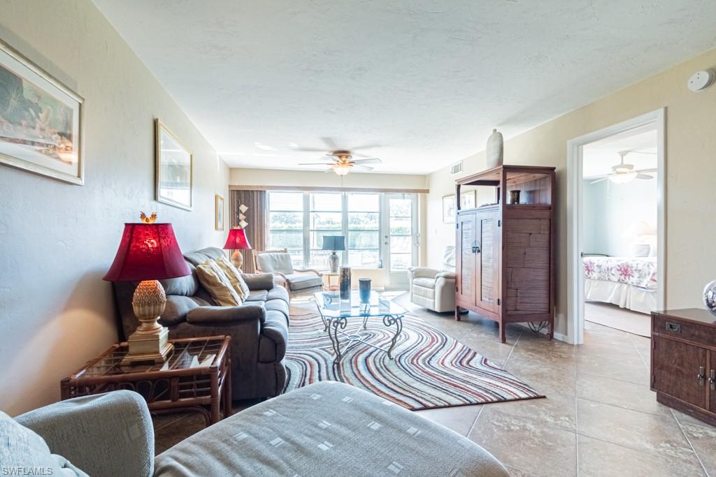 3662 Arctic Circle, Unit 201 Naples, FL 34112 - Photo 13 of 35 a living room with furniture and a large window
