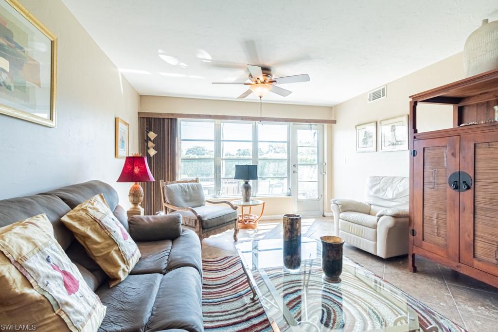 3662 Arctic Circle, Unit 201 Naples, FL 34112 - Photo 14 of 35 a living room with furniture and a large window