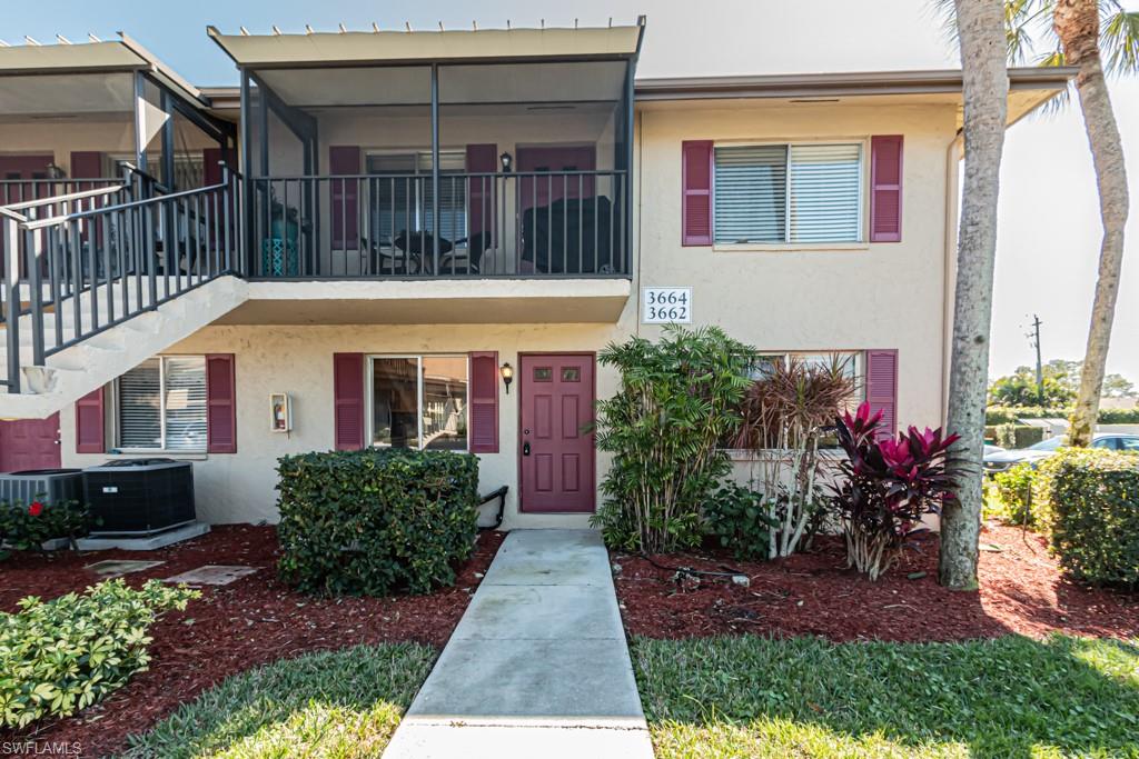 3662 Arctic Circle, Unit 201 Naples, FL 34112 - Photo 2 of 35 a front view of a house with a yard