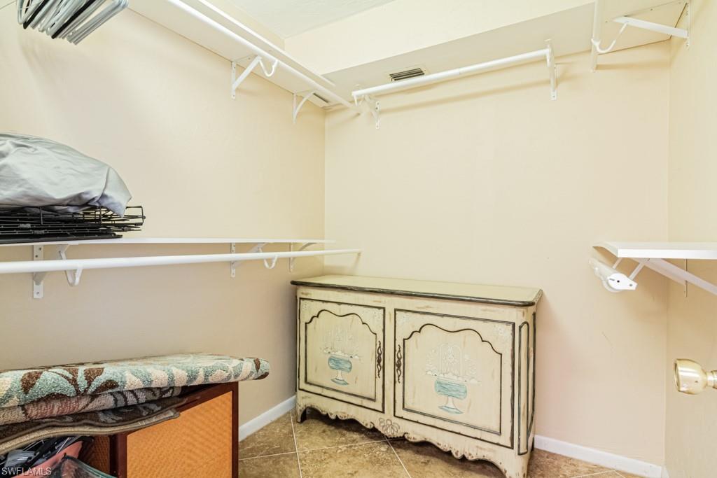 3662 Arctic Circle, Unit 201 Naples, FL 34112 - Photo 22 of 35 a utility room with cabinets