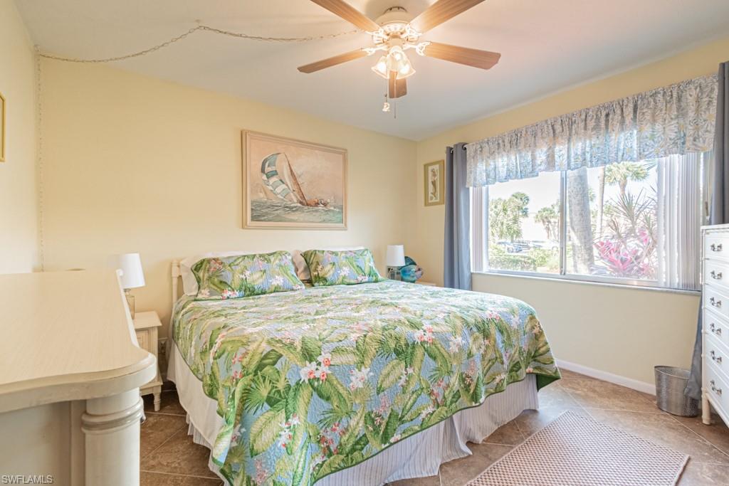 3662 Arctic Circle, Unit 201 Naples, FL 34112 - Photo 23 of 35 a bedroom with a bed and a painting on the wall