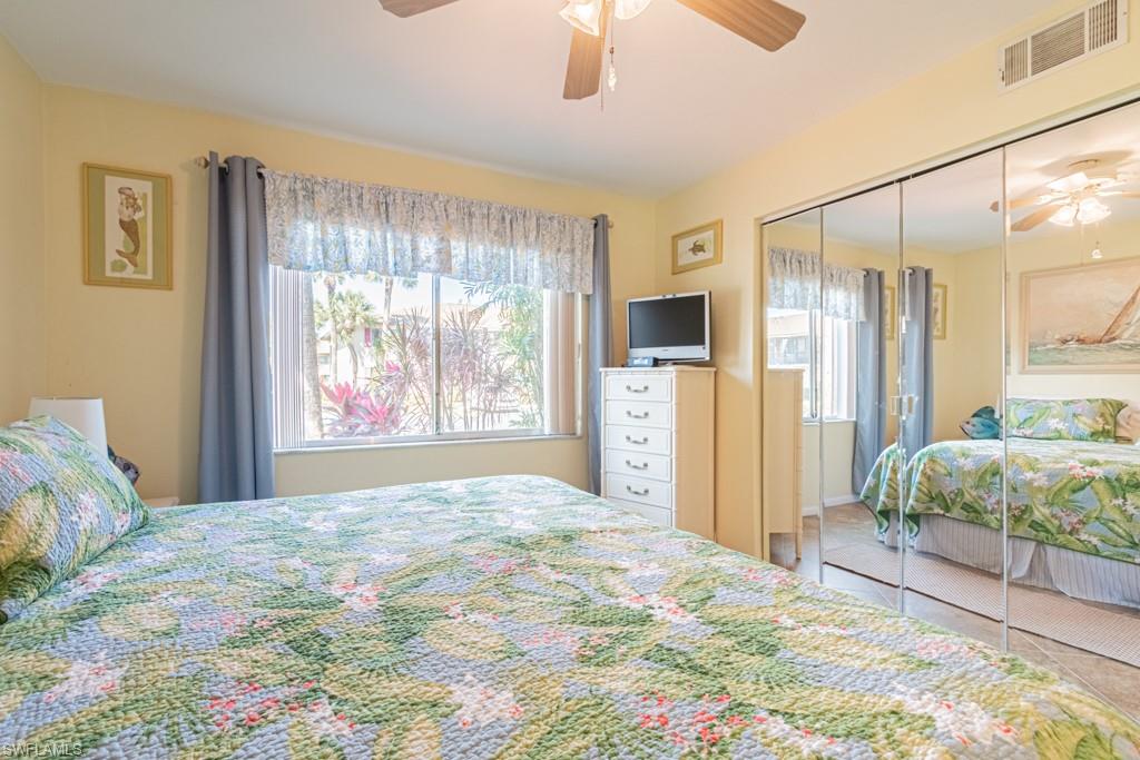 3662 Arctic Circle, Unit 201 Naples, FL 34112 - Photo 24 of 35 a spacious bedroom with a large bed and a window